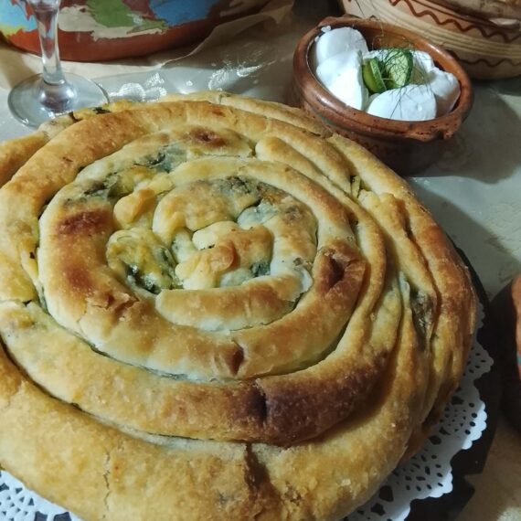 Traditional spiral pastry and homemade dishes arranged on a table