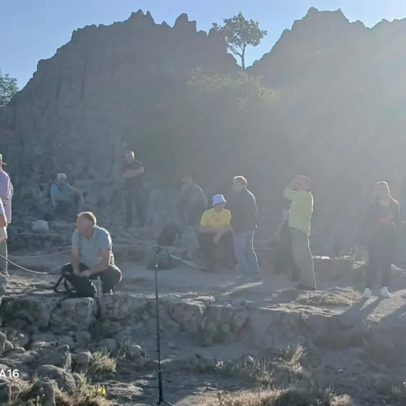 A group exploring the stone terraces at Kokino