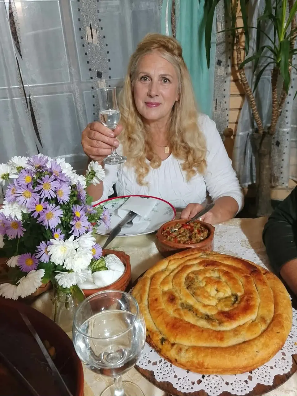 Melita welcoming guests at her homemade table