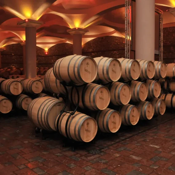 Barrels and warm lighting in Stobi Winery’s cellar
